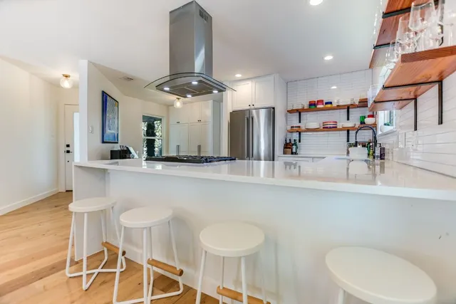 a kitchen with a table and chairs in it