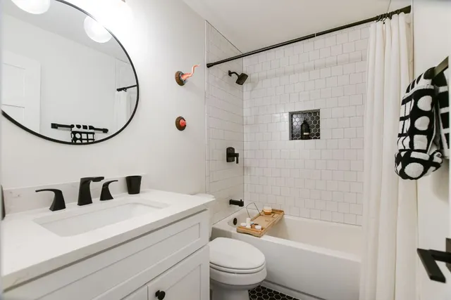 a bathroom with a sink a toilet and a mirror