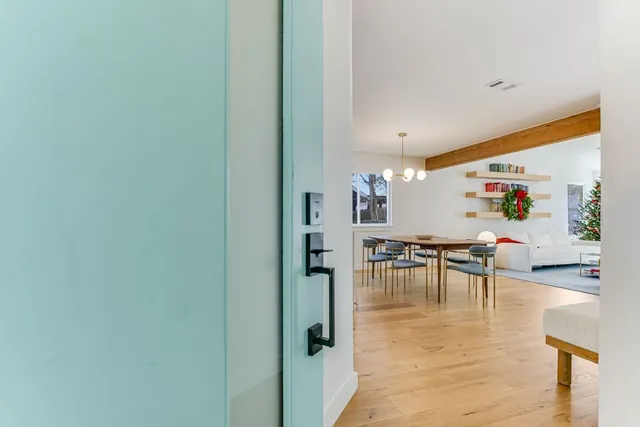 a kitchen with stainless steel appliances a refrigerator a stove and white cabinets