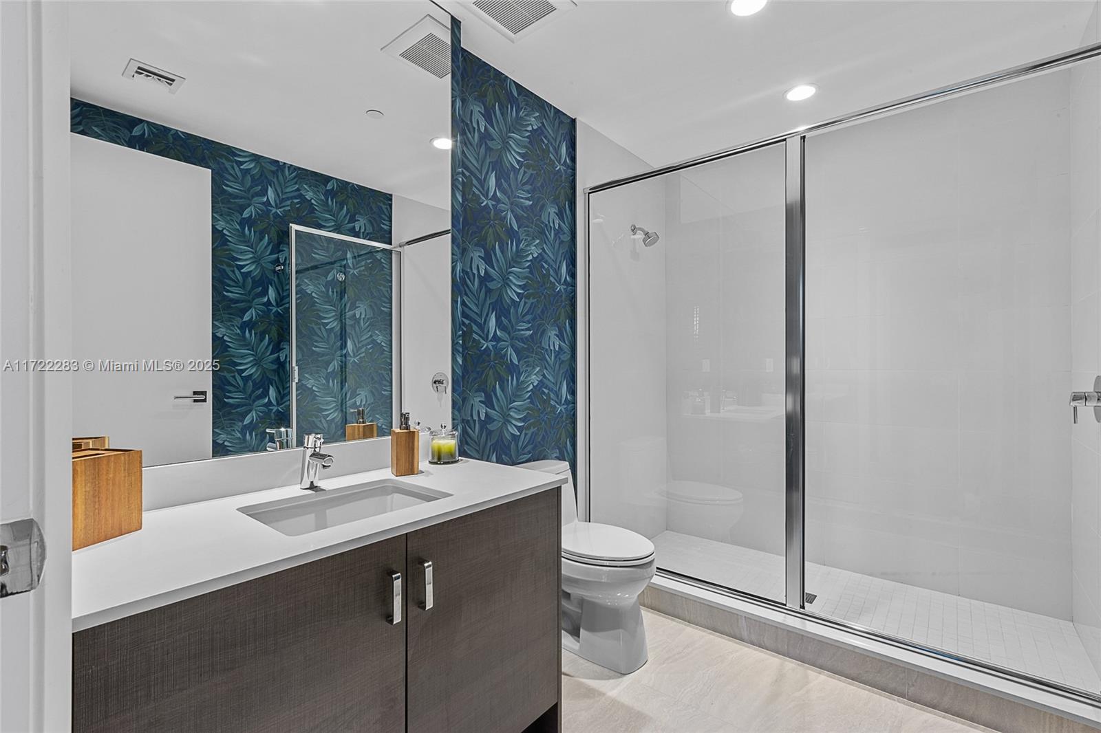 2720 Donald Ross Road, Unit 206 Palm Beach Gardens, FL 33410 - Photo 18 of 40 a bathroom with a double vanity sink toilet and shower