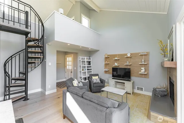 a living room with furniture flat screen tv and a fireplace
