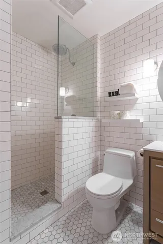 a bathroom with a toilet and a shower