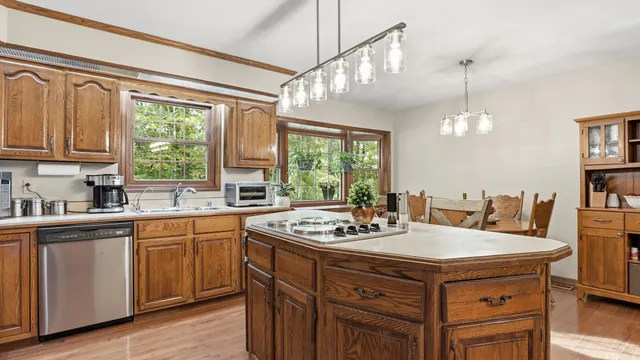 a view of a dining room with furniture large windows and wooden floor