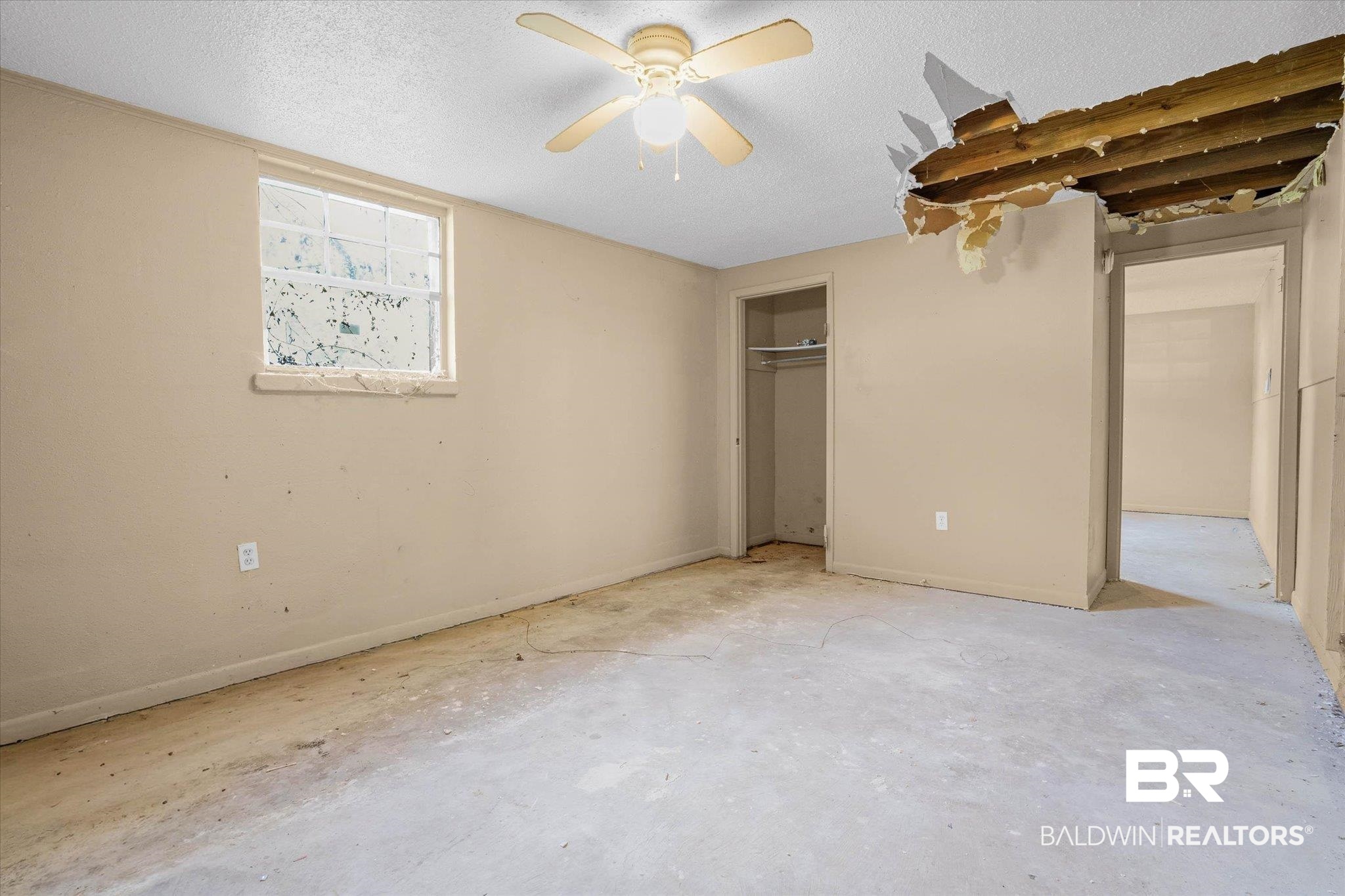 401 Frederick Avenue Fairhope, AL 36532 - Photo 14 of 36 Room with neutral-toned walls, a ceiling fan with light fixture, and a window