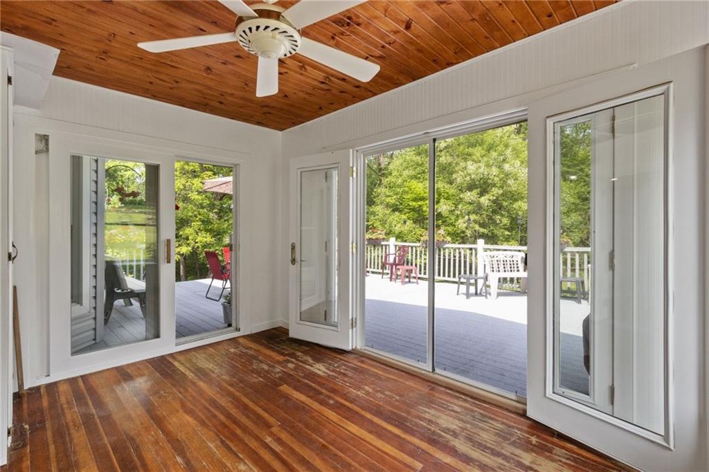 4661 Old Mercer Road Volant, PA 16156 - Photo 12 of 25 Sunporch with barnwood ceiling takes you from the family room out onto the beautiful rear trex deck