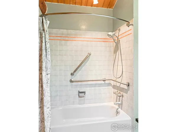 a bathroom with a bathtub and shower