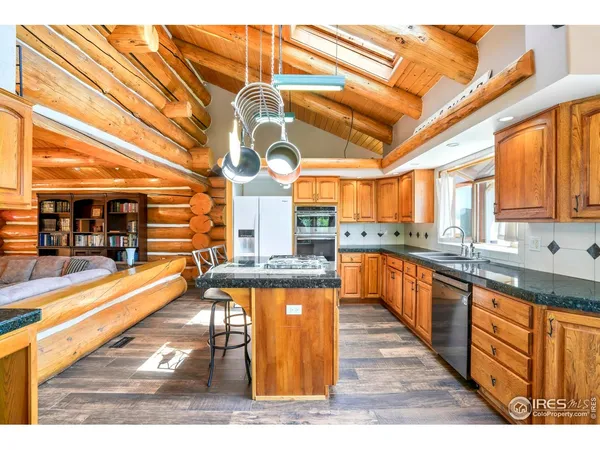 a kitchen with stainless steel appliances granite countertop a sink and cabinets