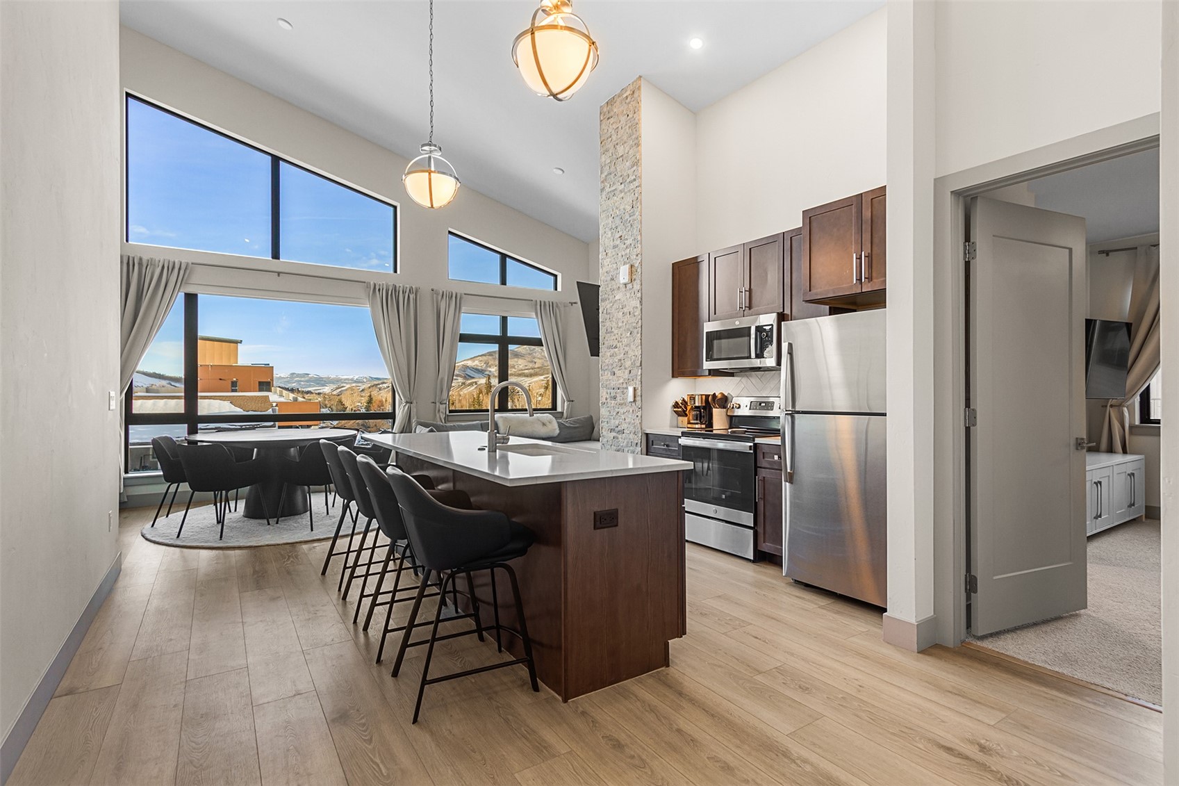 75 West 4th Street, Unit 305W Silverthorne, CO 80498 - Photo 1 of 30 a kitchen with stainless steel appliances a dining table chairs stove and refrigerator