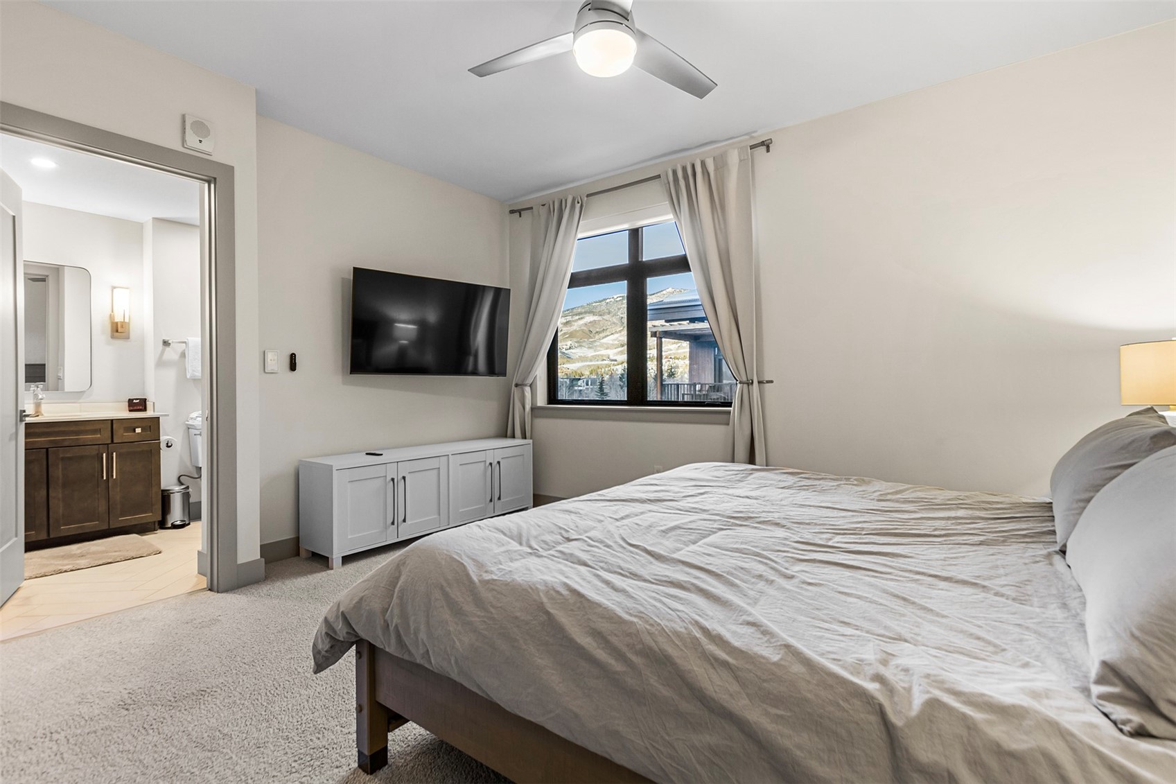 75 West 4th Street, Unit 305W Silverthorne, CO 80498 - Photo 14 of 30 a bedroom with a bed and a flat screen tv