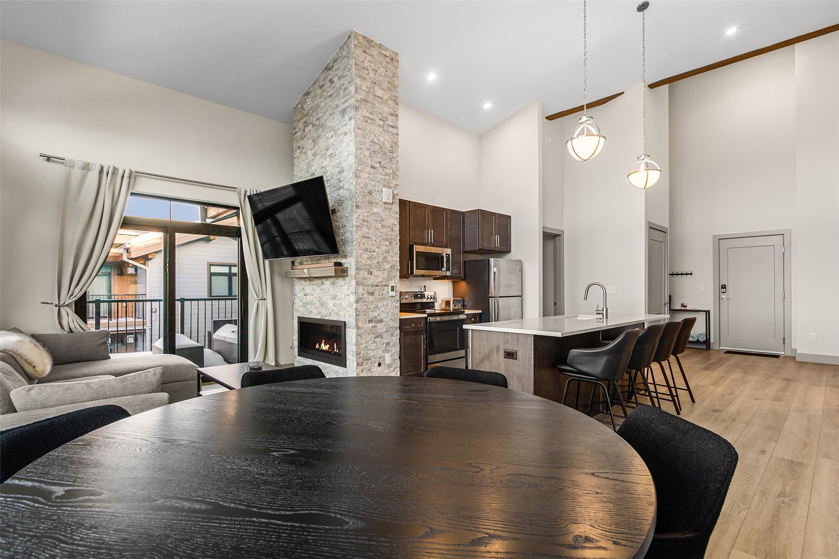 75 West 4th Street, Unit 305W Silverthorne, CO 80498 - Photo 8 of 30 a living room with fireplace furniture dining table and a fireplace
