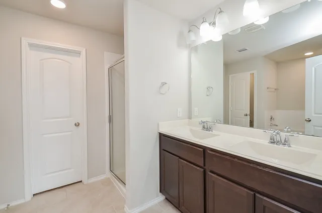 a bathroom with a sink a light fixture and a mirror
