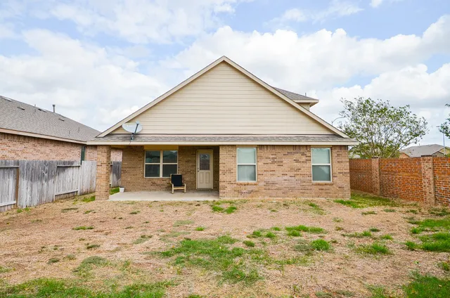 a front view of a house with a yard outdoor seating and garage