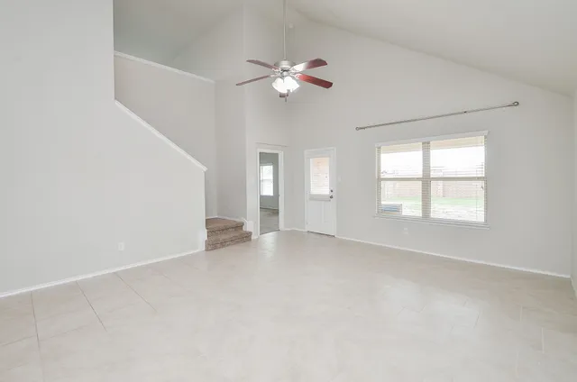 a view of an empty room with a window