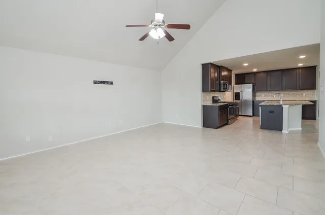 a view of kitchen and chandelier fan