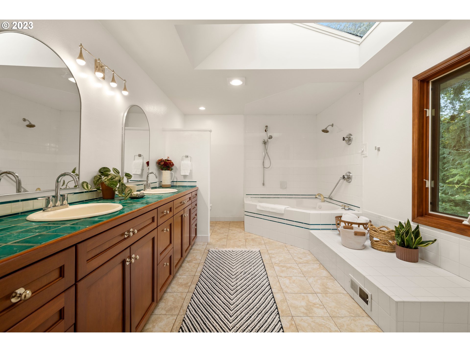 8425 Southwest Ridgeway Drive Portland, OR 97225 - Photo 12 of 41 a spacious bathroom with a double vanity sink and a large mirror