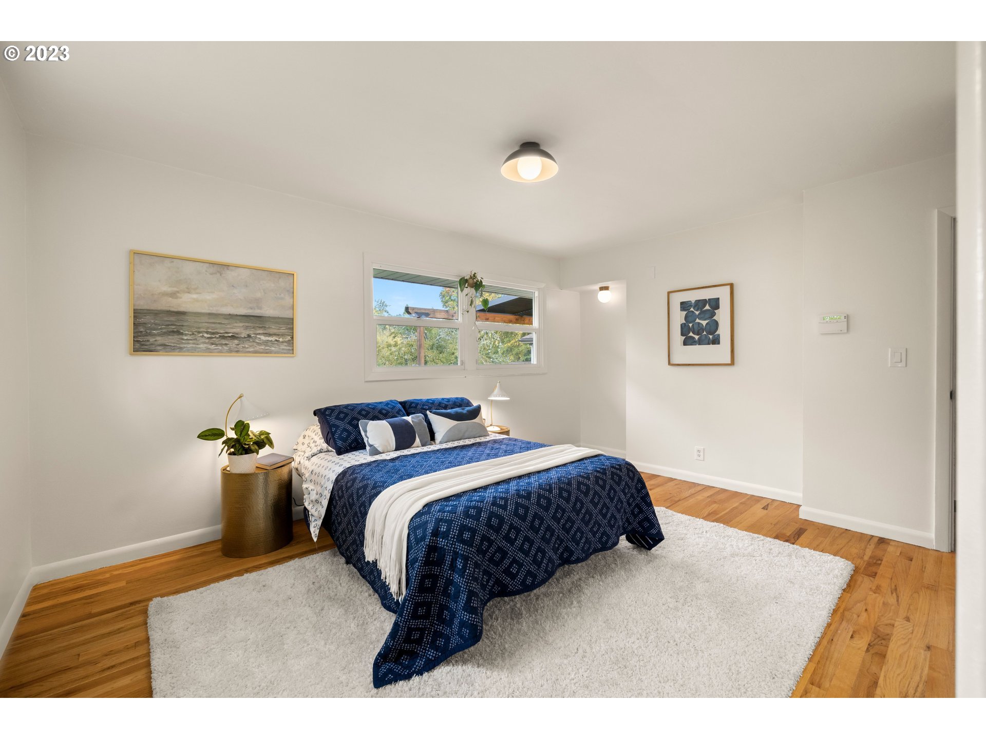 8425 Southwest Ridgeway Drive Portland, OR 97225 - Photo 14 of 41 a bedroom with a bed and painting on the wall