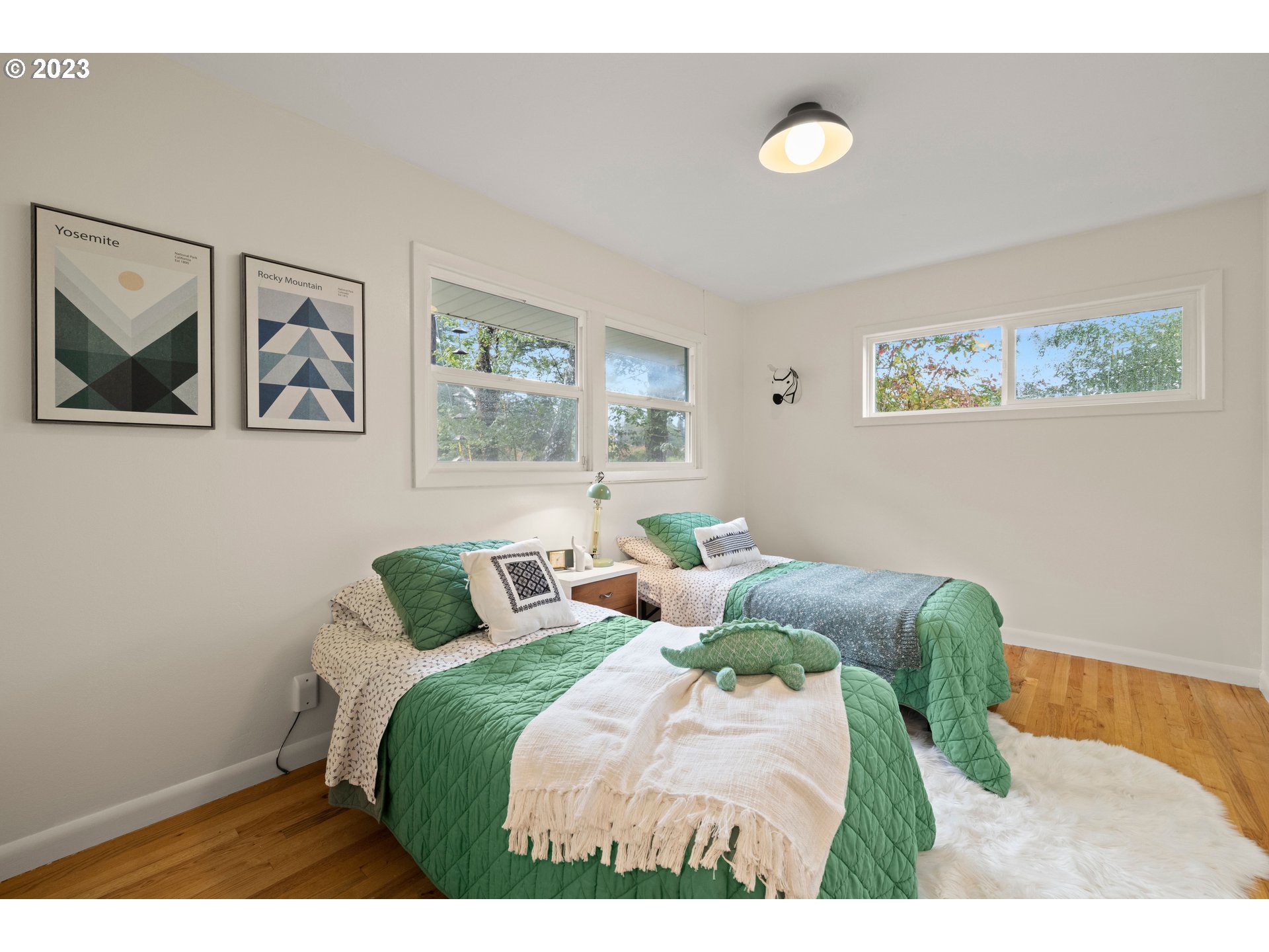 8425 Southwest Ridgeway Drive Portland, OR 97225 - Photo 15 of 41 a bedroom with a bed and painting on the wall