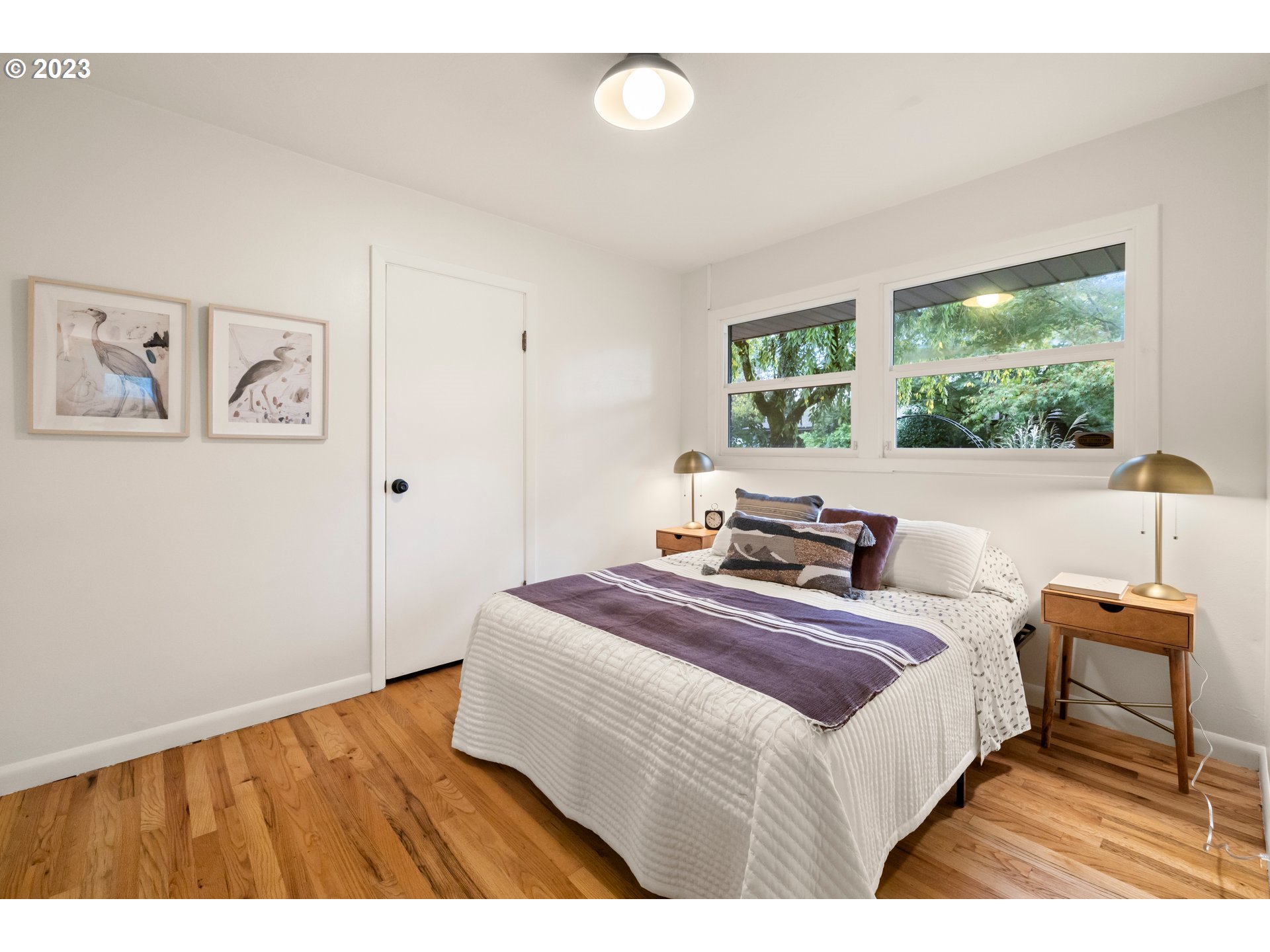 8425 Southwest Ridgeway Drive Portland, OR 97225 - Photo 16 of 41 a bedroom with a bed and a large window