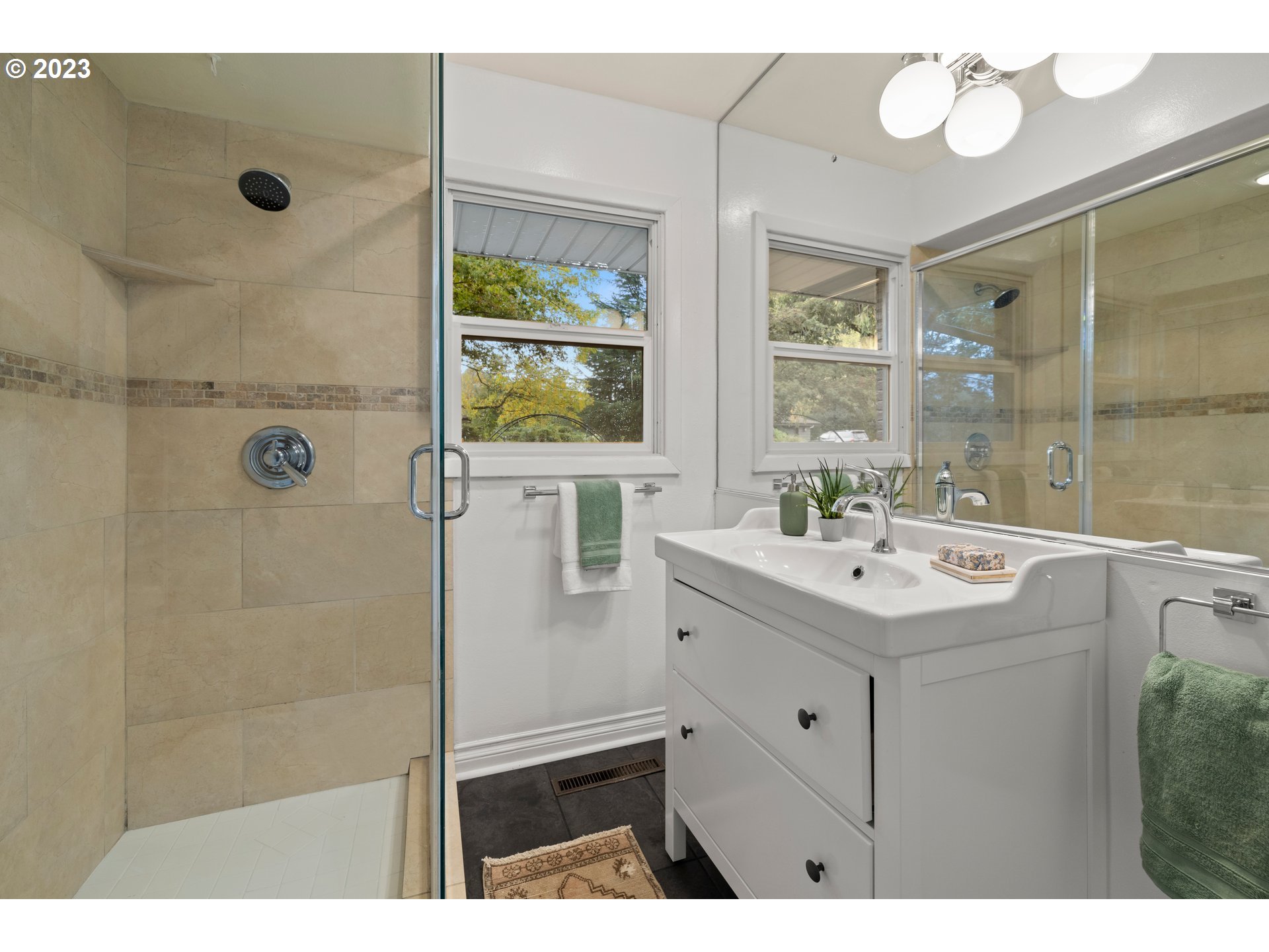 8425 Southwest Ridgeway Drive Portland, OR 97225 - Photo 17 of 41 a bathroom with a sink mirror and a shower