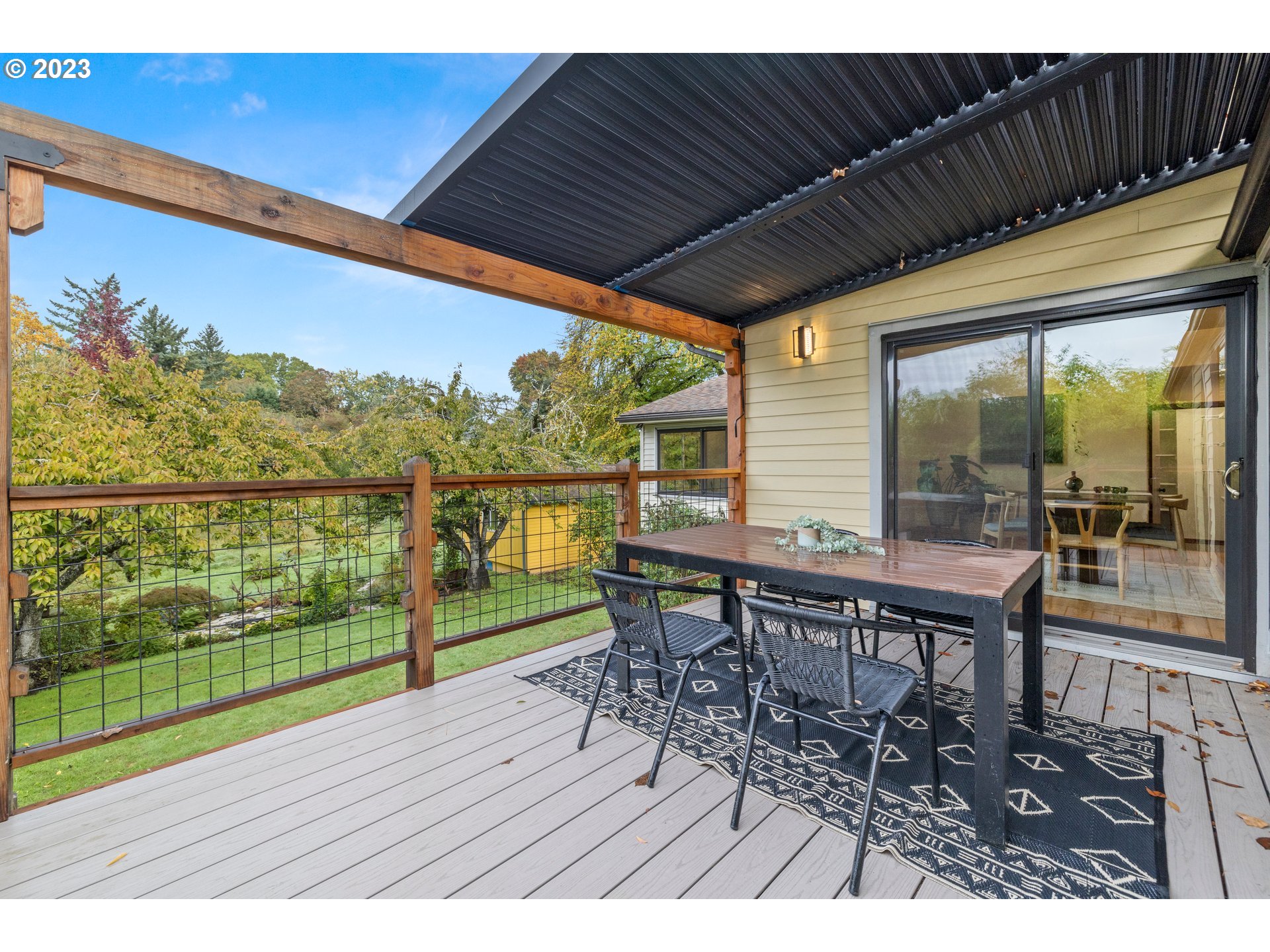 8425 Southwest Ridgeway Drive Portland, OR 97225 - Photo 18 of 41 a view of a chairs and table in patio with wooden floor