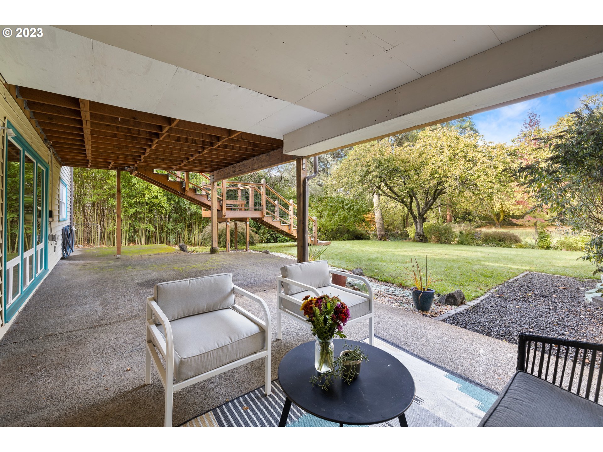 8425 Southwest Ridgeway Drive Portland, OR 97225 - Photo 24 of 41 a view of a patio with a table chairs and a backyard