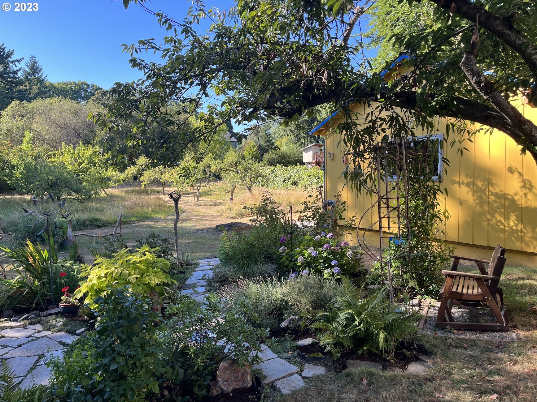 8425 Southwest Ridgeway Drive Portland, OR 97225 - Photo 32 of 41 a backyard of a house with lots of green space and fountain