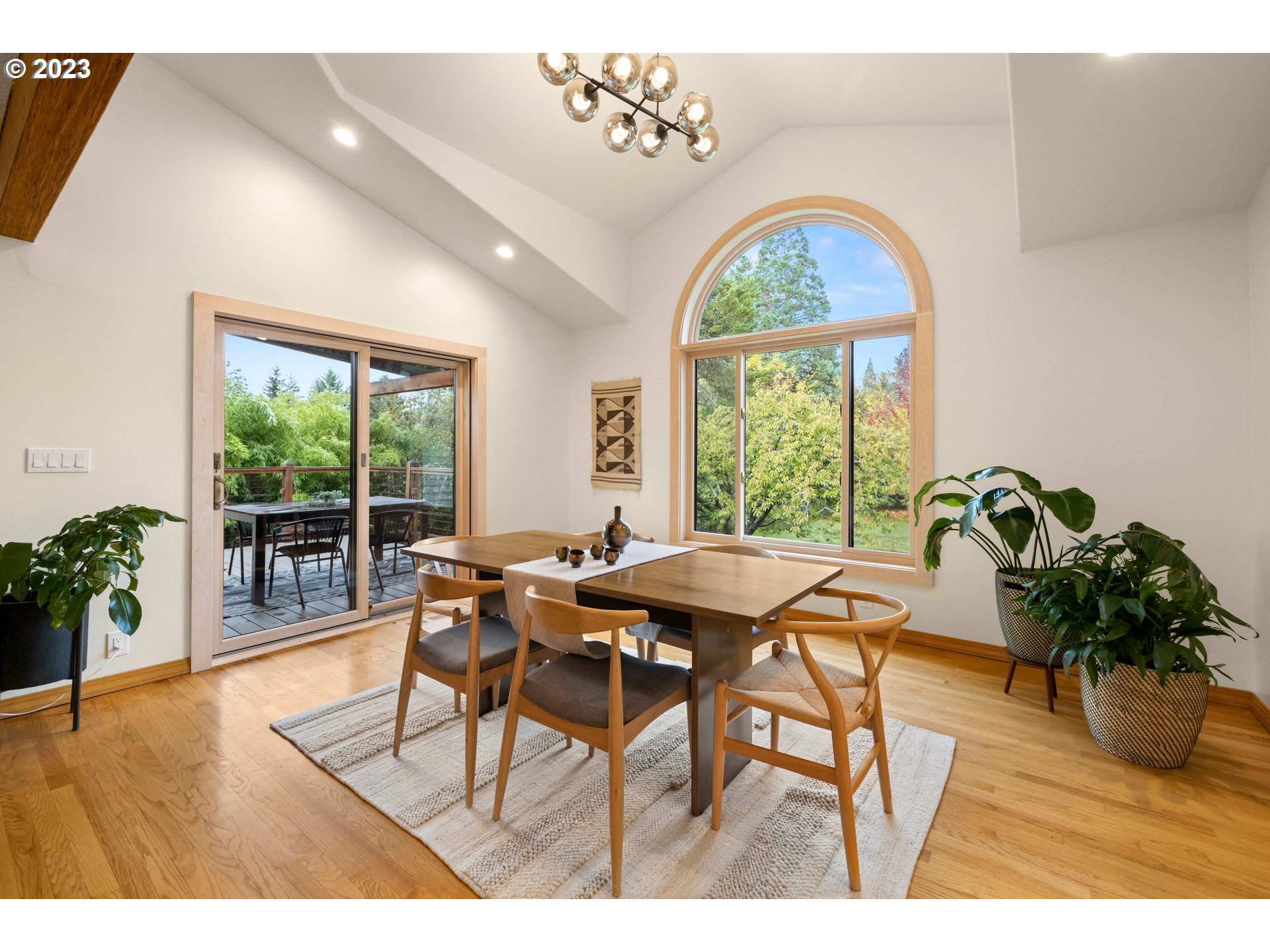 8425 Southwest Ridgeway Drive Portland, OR 97225 - Photo 4 of 41 a dining room with furniture window outside view and wooden floor