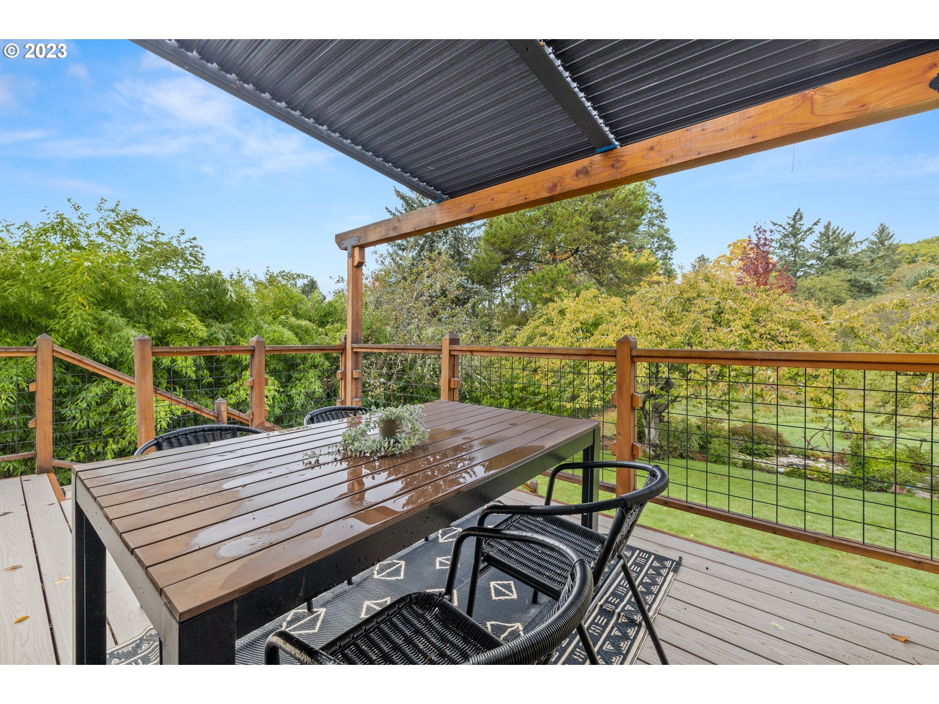 8425 Southwest Ridgeway Drive Portland, OR 97225 - Photo 6 of 41 a view of a deck with wooden floor and outdoor seating