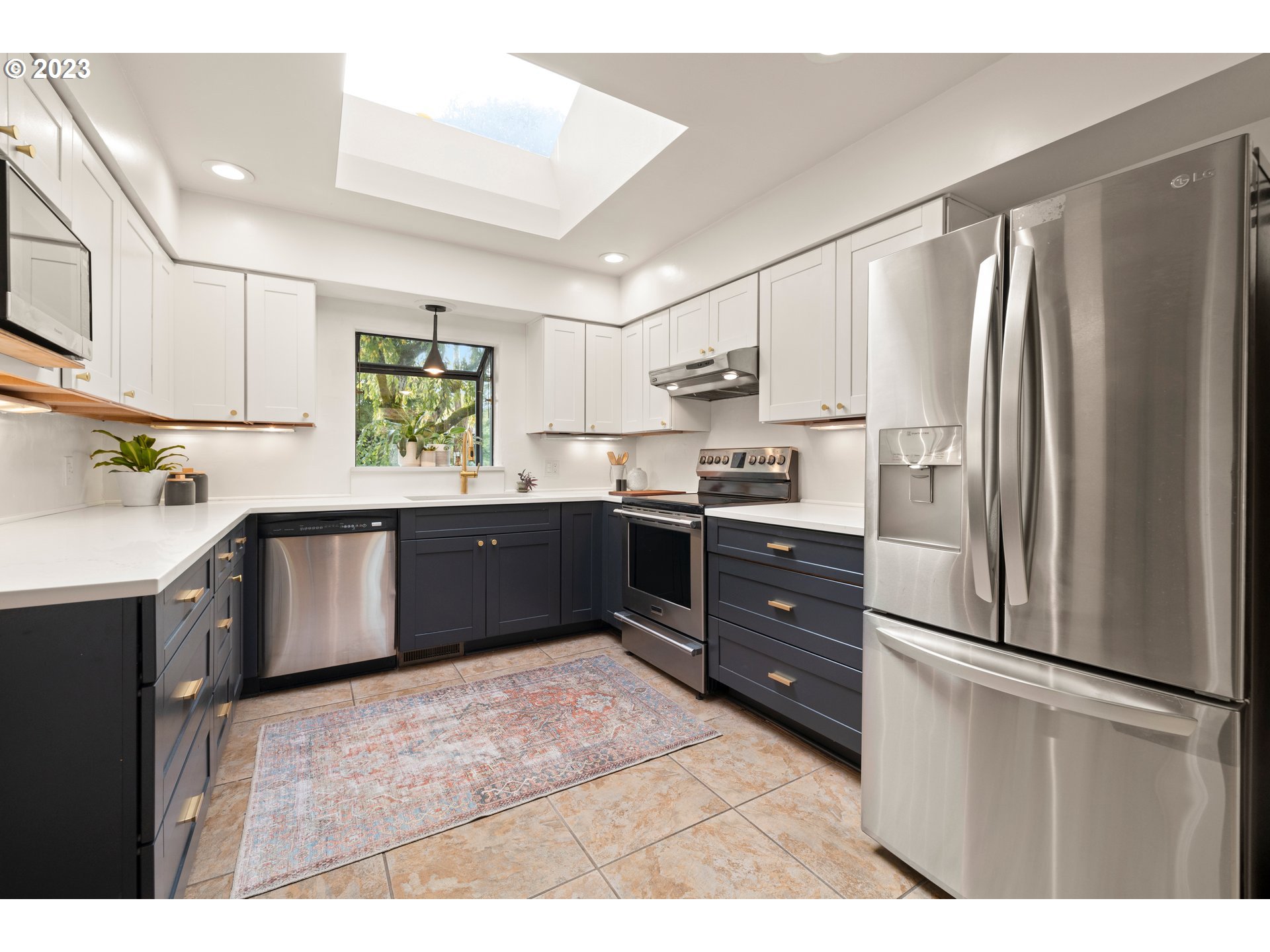 8425 Southwest Ridgeway Drive Portland, OR 97225 - Photo 8 of 41 a kitchen with stainless steel appliances granite countertop a refrigerator a sink dishwasher a stove with white cabinets