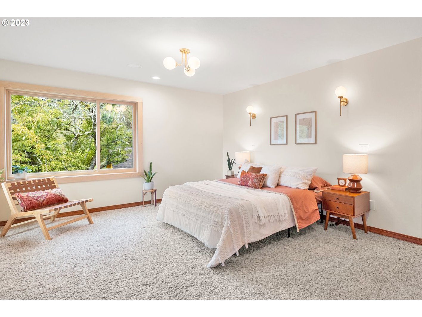 8425 Southwest Ridgeway Drive Portland, OR 97225 - Photo 10 of 41 a bedroom with a bed and a large window