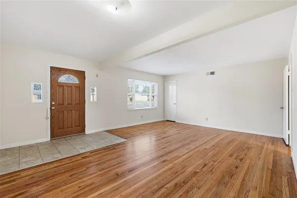 an empty room with windows and closet