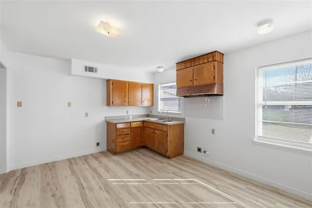 a room with a flat screen tv and cabinets