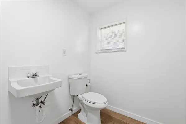a bathroom with a sink toilet and mirror