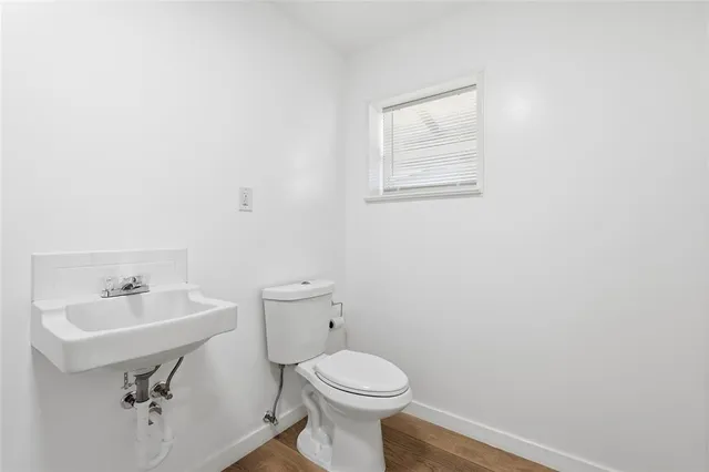 a bathroom with a sink toilet and mirror