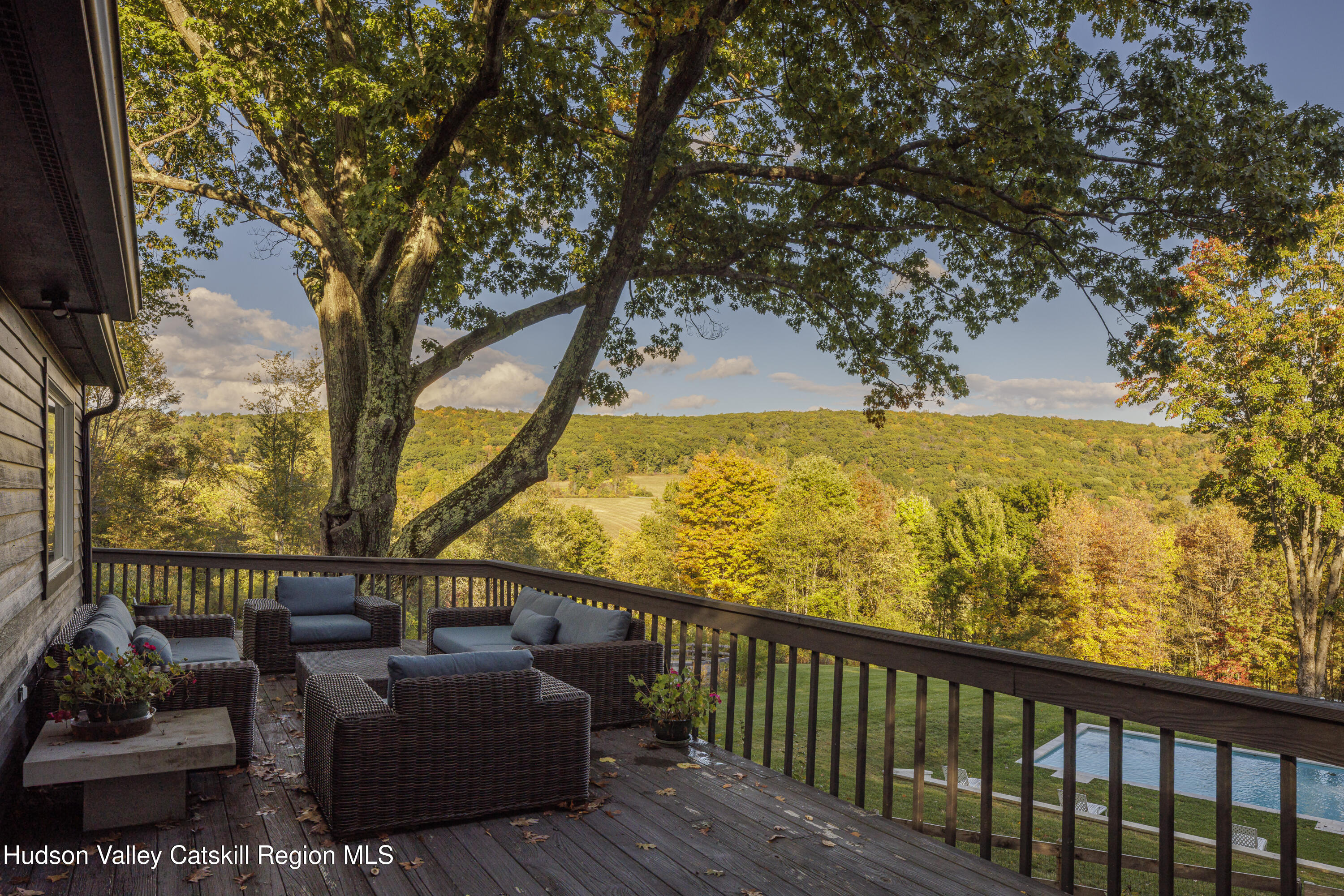 181 Lockwood Road Craryville, NY 12521 - Photo 5 of 19 a balcony with wooden floor and outdoor seating
