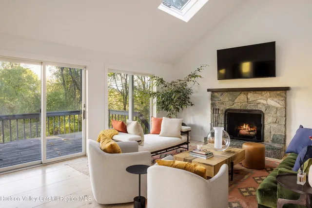 a kitchen with stainless steel appliances granite countertop a refrigerator a stove and a sink with wooden floor