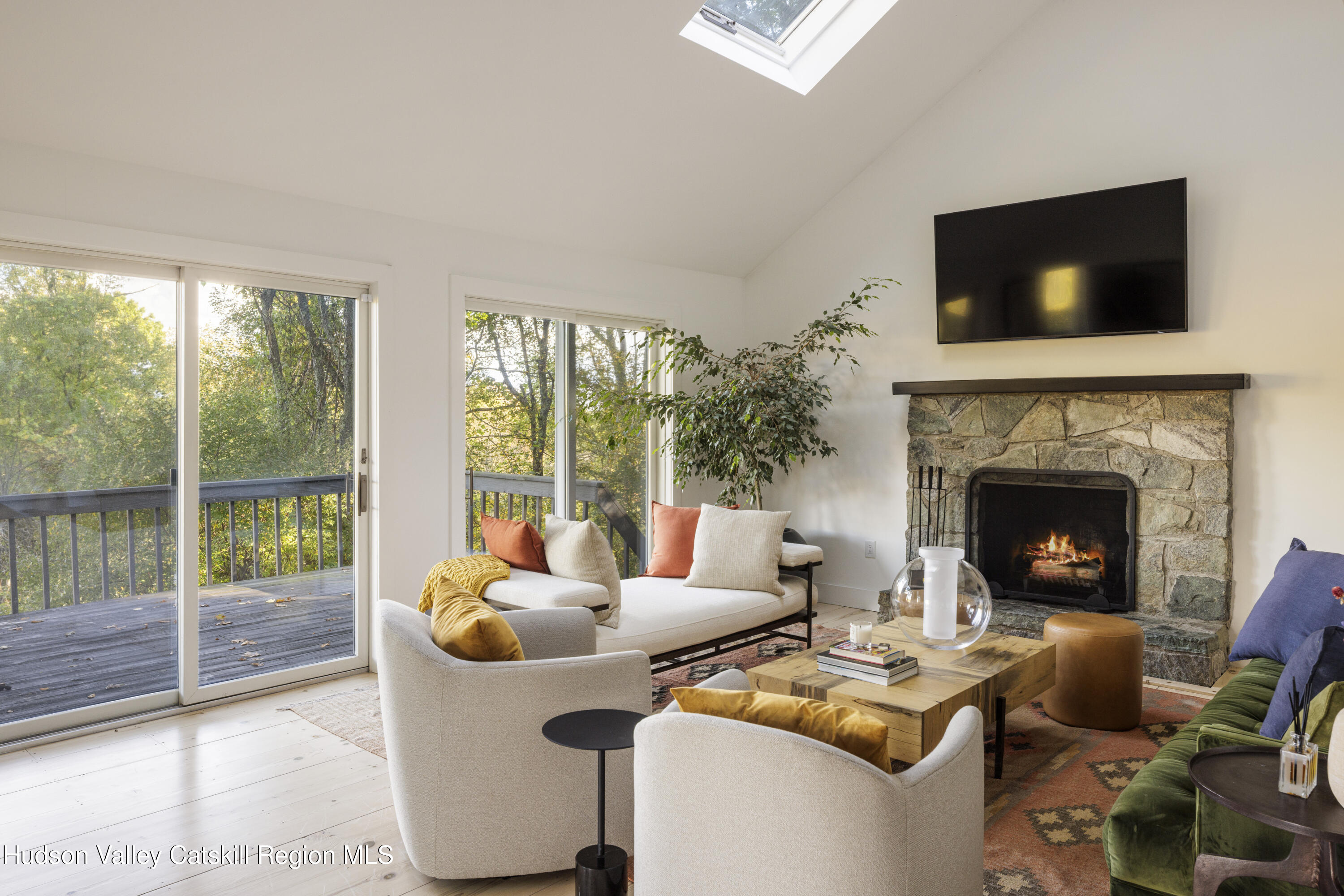 181 Lockwood Road Craryville, NY 12521 - Photo 7 of 19 a living room with furniture a flat screen tv and a fireplace