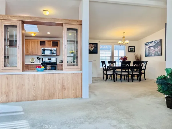 a view of a dining room with furniture a chandelier and wooden floor