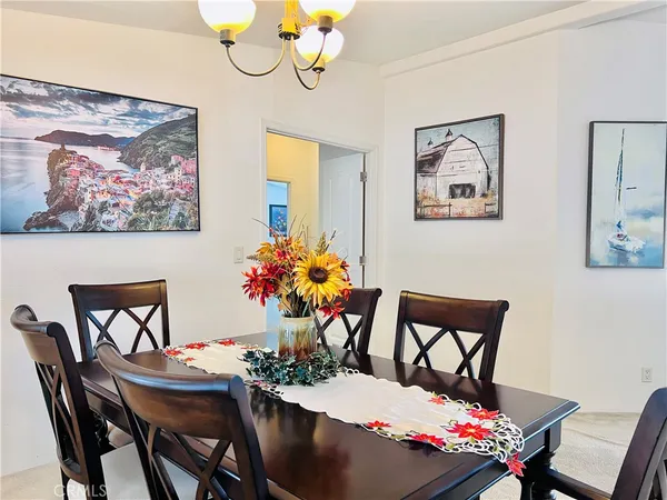 a view of a dining room with furniture and a chandelier
