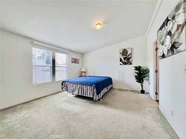 an empty room with a painting on the wall