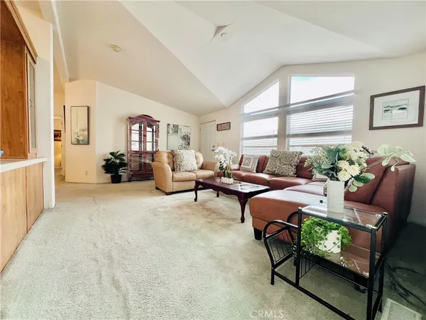 a living room with furniture and flowers