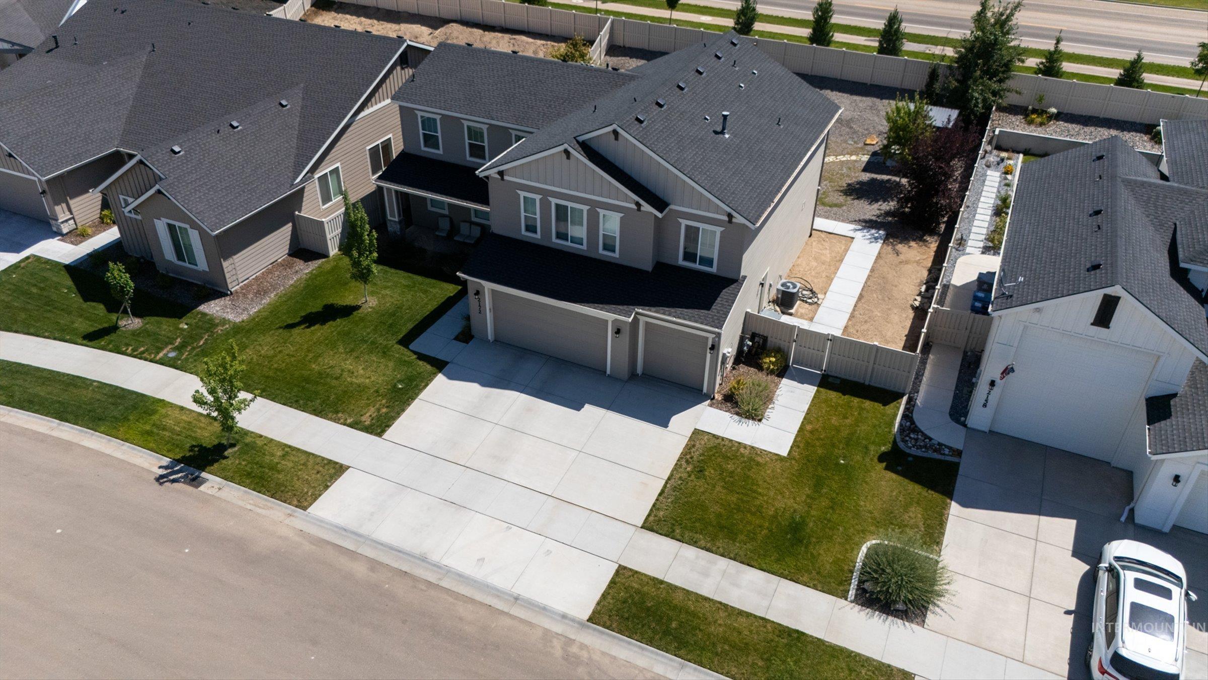 2172 Savoy Court Middleton, ID 83644 - Photo 39 of 46 Two-story property featuring light gray siding with dark trim, a dark shingle roof, and an attached two-car garage
