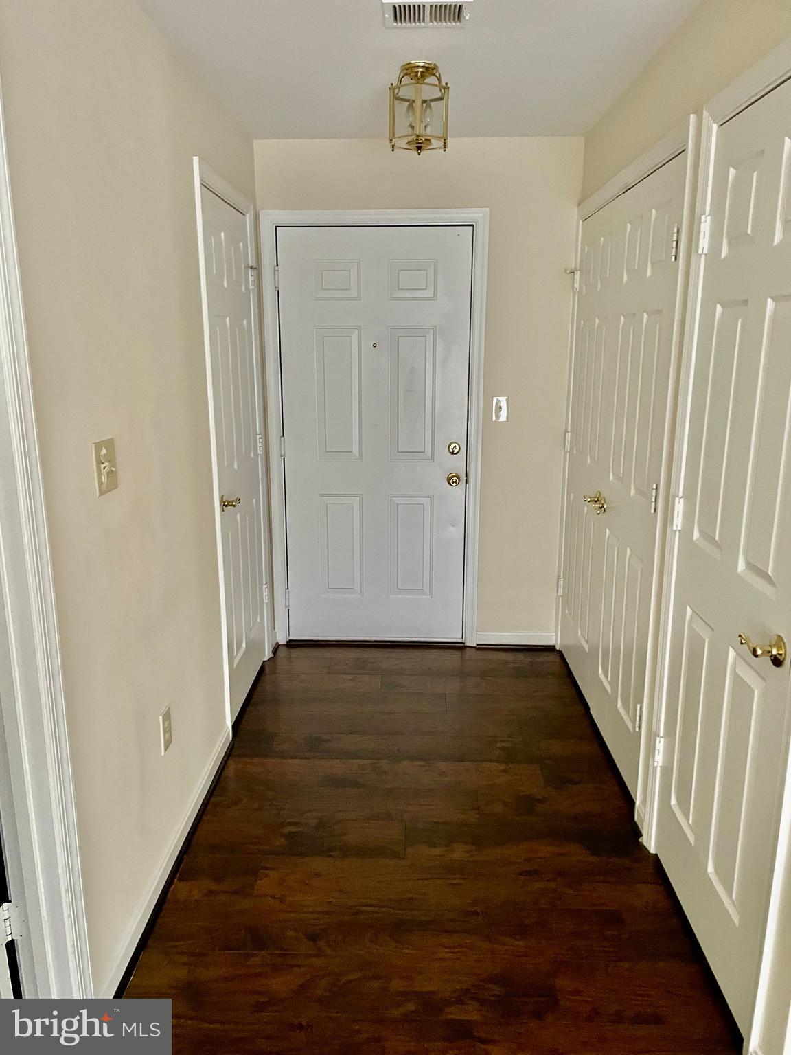 102 Kendrick Place, Unit 10222 Gaithersburg, MD 20878 - Photo 4 of 17 a view of a hallway with wooden floor