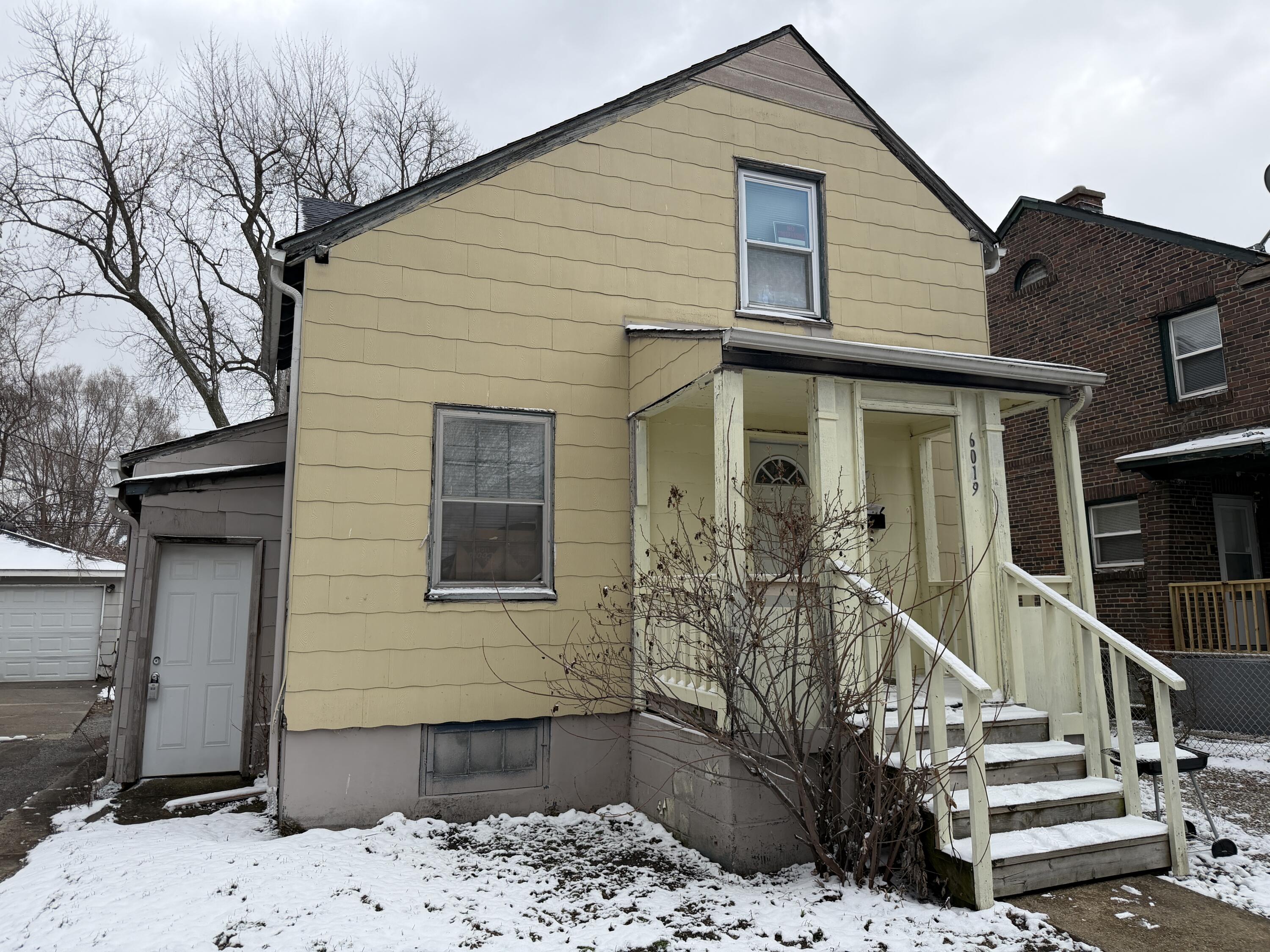 a front view of a house with stairs