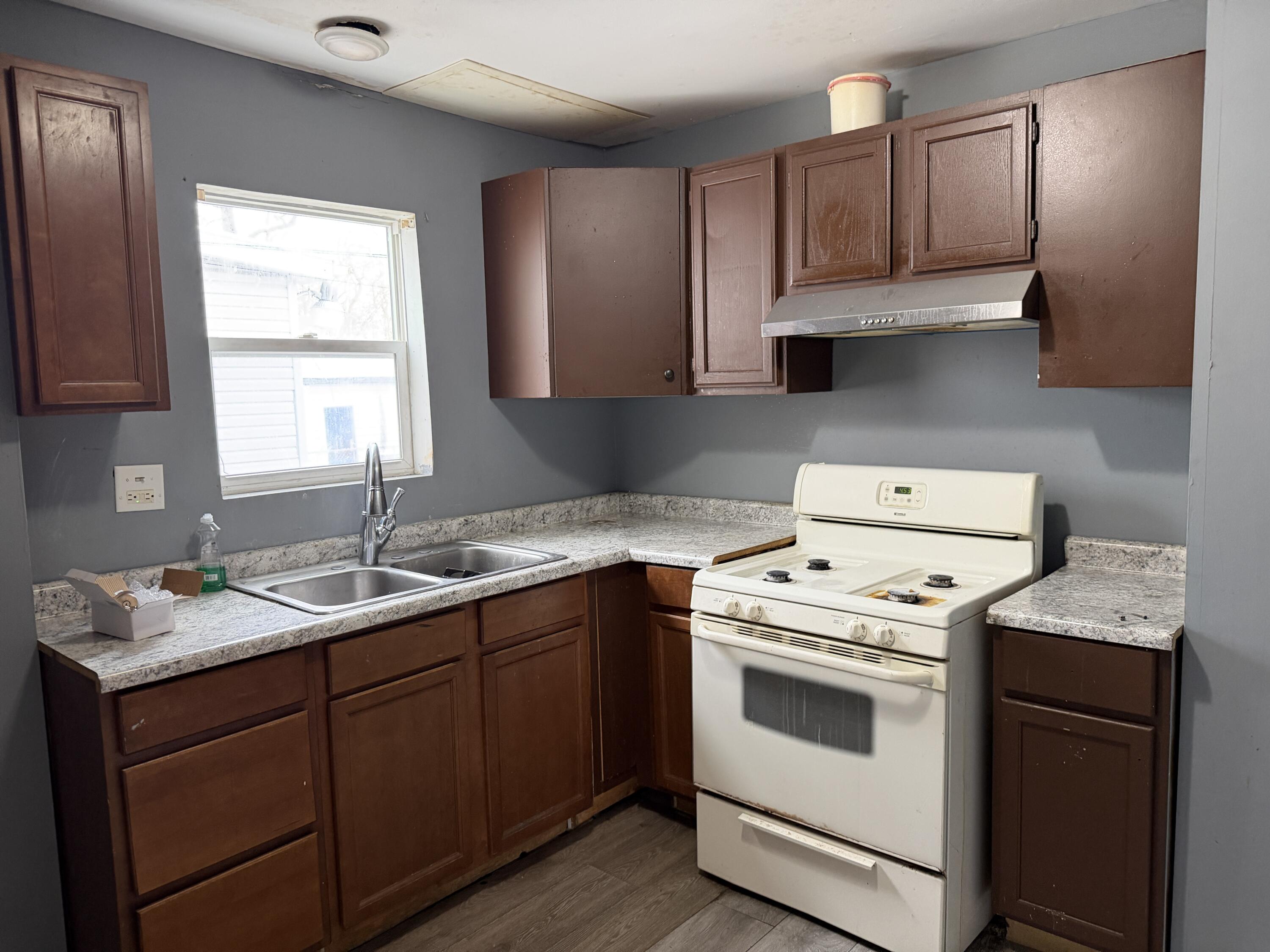 6019 Wallace Road Hammond, IN 46320 - Photo 3 of 10 a kitchen with a sink stove top oven and cabinets