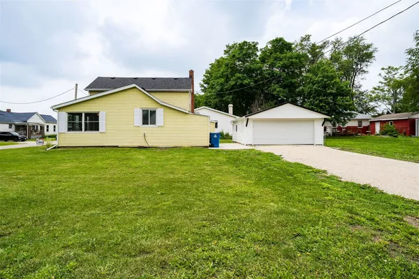 a front view of house with yard and trees