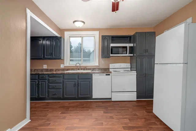 a kitchen with a refrigerator and a sink