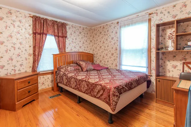 a bedroom with a bed and window