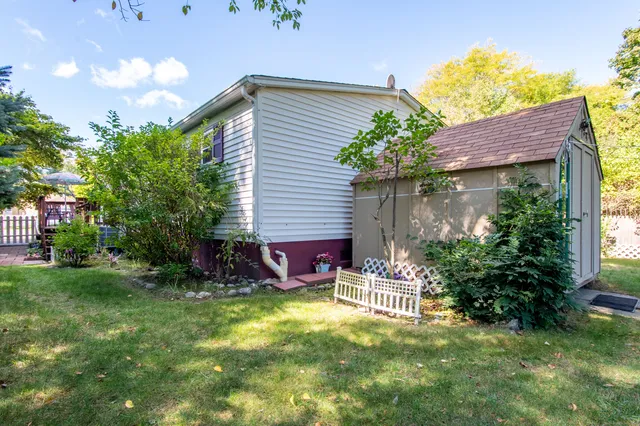 a view of house with backyard and outdoor seating
