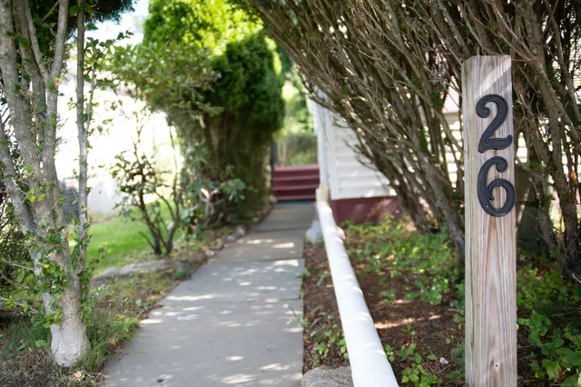 a front view of a house with garden